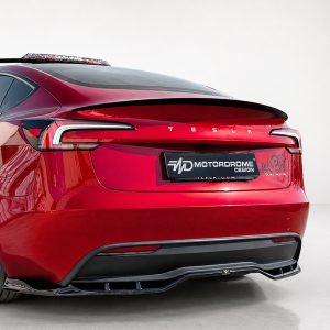 Rear view of a red Tesla with a Motordrome Design plate and roof rack visible on top rear edge.