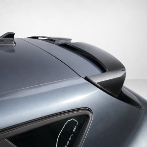 Back portion of a metallic blue sports car showing a rear spoiler and curved window line.