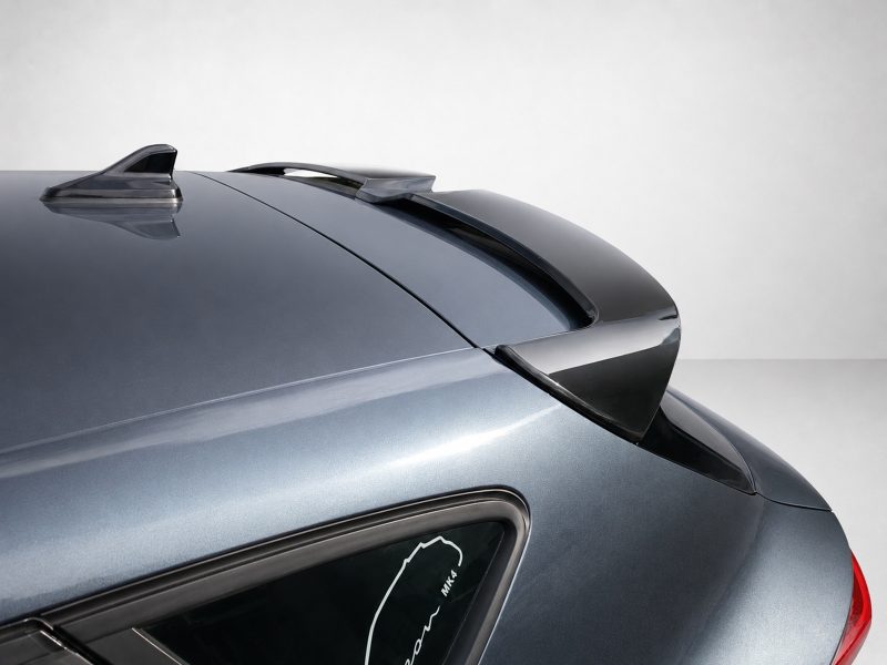 Back portion of a metallic blue sports car showing a rear spoiler and curved window line.