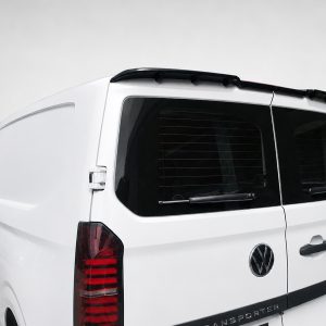 White VW Transporter van shown from the rear-left, displaying the rear windows, wiper, and roof spoiler.