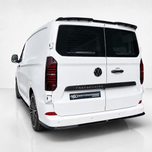 White VW Transporter van seen from rear-left, customized with a black rear bumper trim and company badge on the tailgate