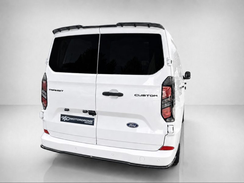Rear view of a white Ford Transit Custom van with dark-tinted rear windows and a MotorDrome Design plate.