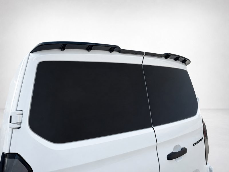 White cargo van rear side with black-tinted windows and a small roof spoiler along the top edge.