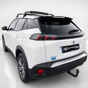 A-513_2jpg - OPSHOLDERS Rear three-quarter view of a white Peugeot SUV with black roof panels, a roof rack, and prominent taillights in a studio setting.