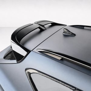 Close-up of the rear of a sleek blue car, highlighting the spoiler and glossy roof panels.