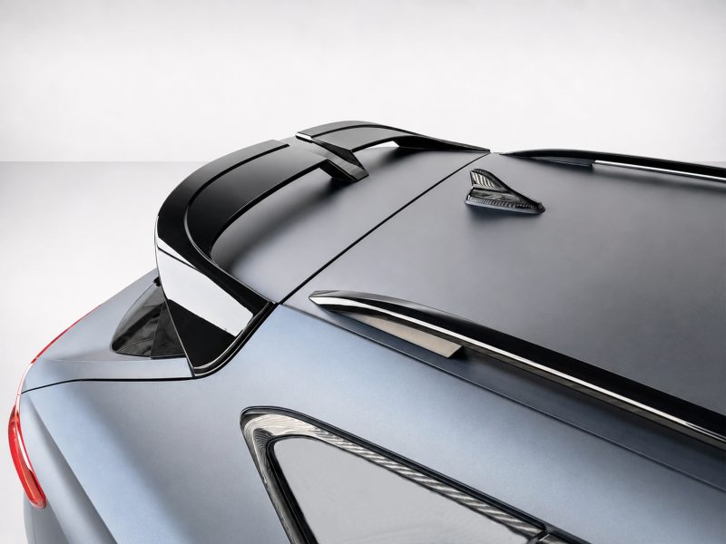 Close-up of the rear of a sleek blue car, highlighting the spoiler and glossy roof panels.