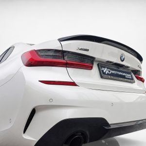 White BMW car rear view with XDrive badge and red taillights on a white backdrop