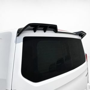 Rear view of a white SUV with a black aerodynamic roof spoiler above the rear window and spoiler fins on each side.