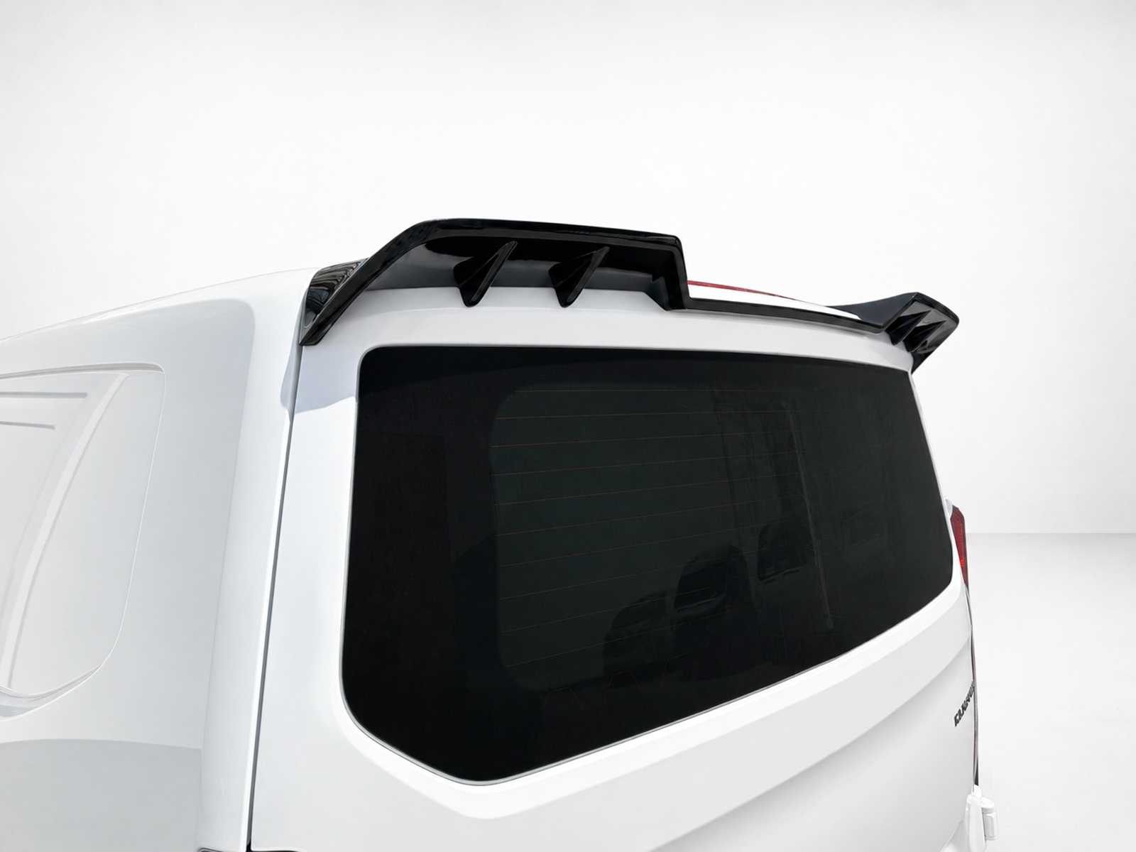 A-517_1jpg - OPSHOLDERS Rear view of a white SUV with a black aerodynamic roof spoiler above the rear window and spoiler fins on each side.