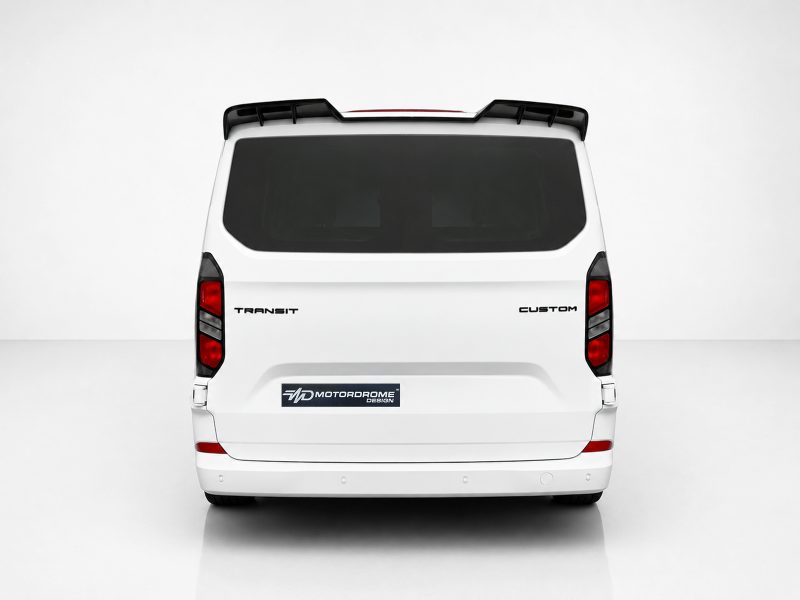 A-517_3jpg - OPSHOLDERS Rear view of a white van with tinted rear window, roof rack, and badges reading TRANSIT and CUSTOM; shows a vehicle design image.