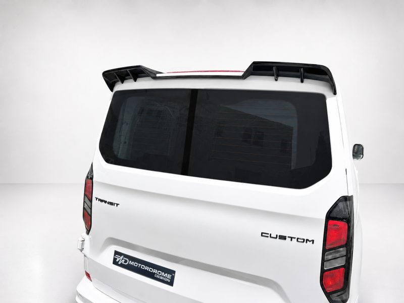 A-517_5jpg - OPSHOLDERS Rear view of a white Ford Transit Custom van with a black roof spoiler and tinted rear window