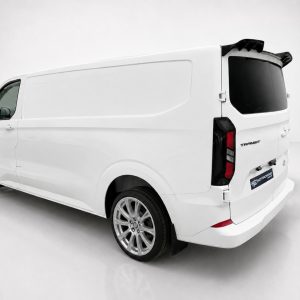 White cargo van shown from a rear-left angle in a clean, studio setting, highlighting its large cargo area and tinted rear window.