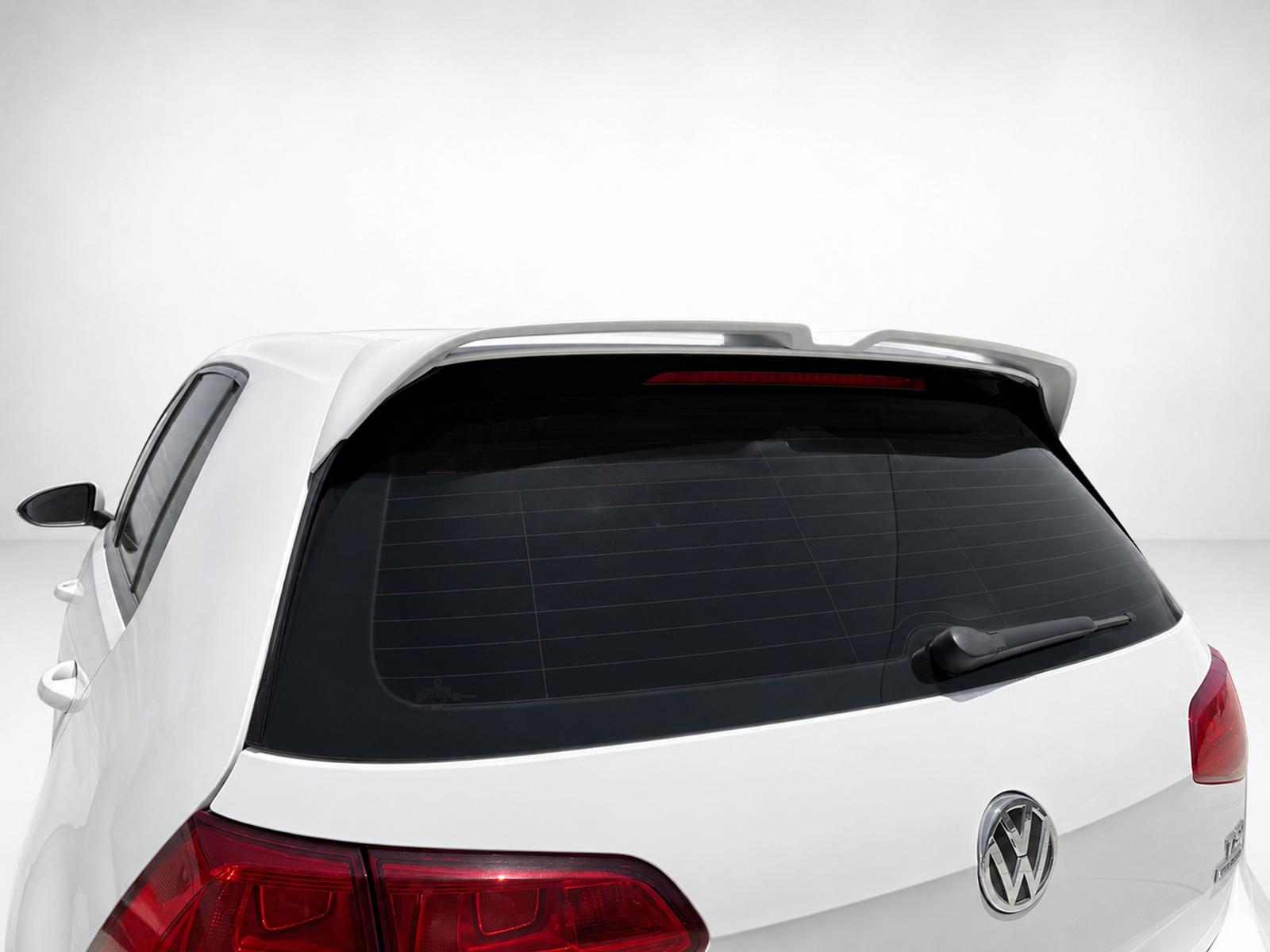 A-521_1jpg - OPSHOLDERS Rear of a white Volkswagen SUV with a roof spoiler and rear windshield wiper