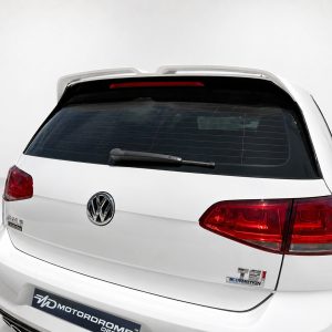 A-521_6jpg - OPSHOLDERS Rear view of a white Volkswagen SUV with a roof spoiler and red taillights in a clean studio setting.