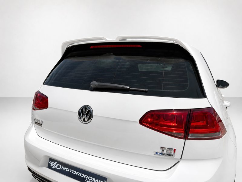 A-521_6jpg - OPSHOLDERS Rear view of a white Volkswagen SUV with a roof spoiler and red taillights in a clean studio setting.