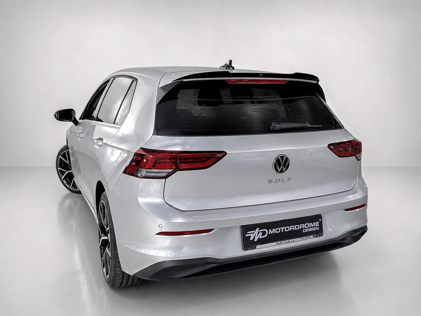 A-522_2jpg - OPSHOLDERS Rear view of a silver Volkswagen Golf wagon in a studio, showing taillights and large black alloy wheels.