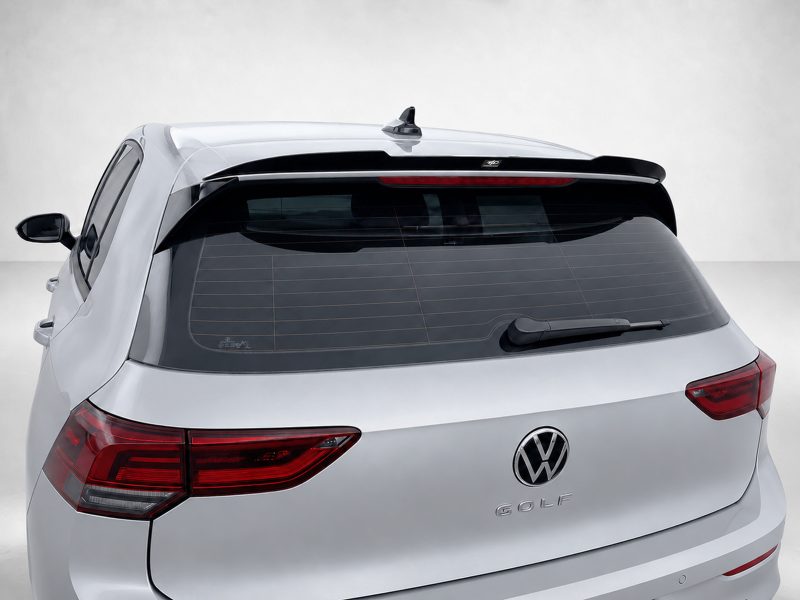 A-522_4jpg - OPSHOLDERS Rear view of a silver VW Golf hatchback with a roof spoiler, shark fin antenna, and prominent VW logo on the trunk.