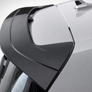 A-525_4jpg - OPSHOLDERS Close-up of a sleek car door with a large frameless window and glossy black panel.