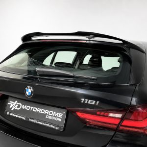 Black BMW hatchback rear with spoiler and visible 118i badge, advertising a car showroom plate area at the bottom left.