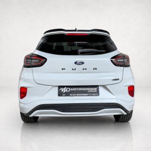 A-531_3jpg - OPSHOLDERS Rear view of a white Ford Puma SUV with a black roof spoiler and visible MOTORDROME Car Center license plate area