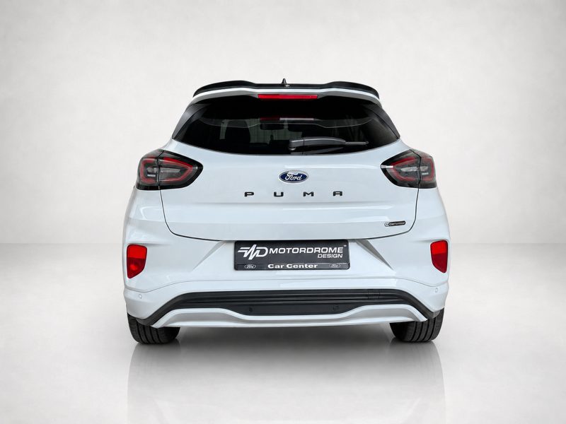 A-531_3jpg - OPSHOLDERS Rear view of a white Ford Puma SUV with a black roof spoiler and visible MOTORDROME Car Center license plate area