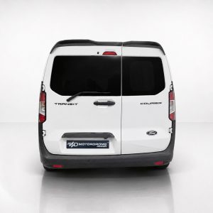 White Ford Transit Courier van seen from the rear, split doors, dark windows, rear wiper, and Motordrome Design plate on the bumper area.