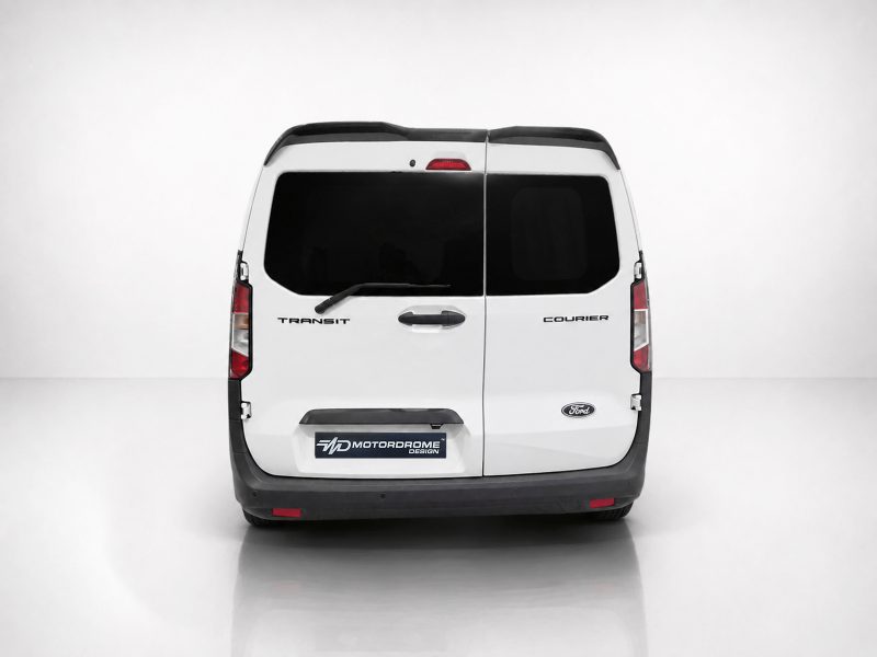 White Ford Transit Courier van seen from the rear, split doors, dark windows, rear wiper, and Motordrome Design plate on the bumper area.