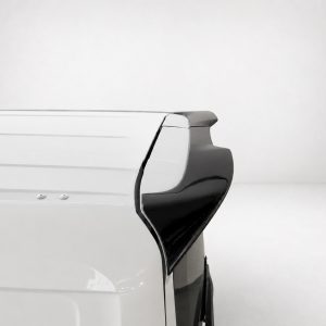 Rear right corner of a white van with a black rear spoiler against a plain light background.