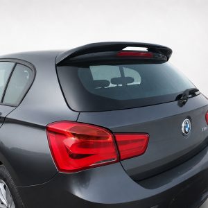 Rear view of a gray BMW hatchback with a roof spoiler and rear wiper on a light background