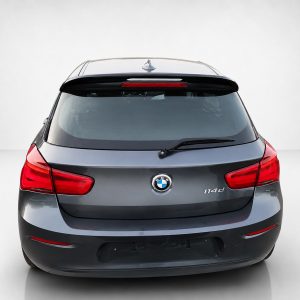 Rear view of a gray BMW SUV featuring red taillights, rear windshield wiper, and roof rails.
