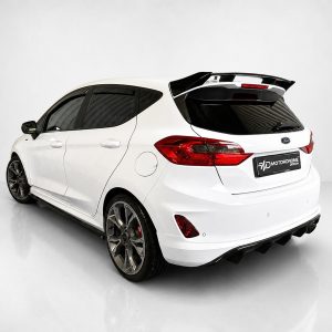 A-535_2jpg - OPSHOLDERS White modified hatchback viewed from the rear-quarter, featuring a large wing, dark-tinted windows, and custom alloy wheels in a studio setting.