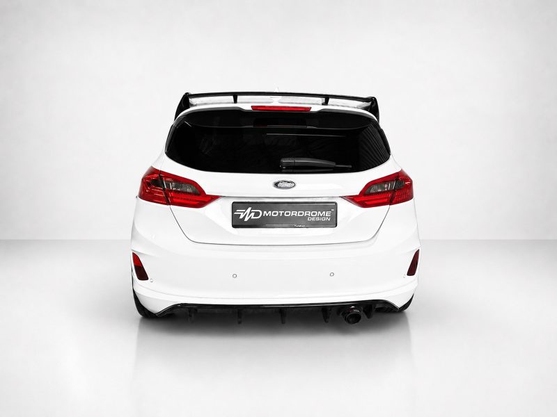 A-535_3jpg - OPSHOLDERS Rear view of a white Ford hatchback with red taillights and a Motordrome Design license plate.