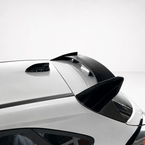 A-538_4jpg - OPSHOLDERS Close-up of a white car's rear with a black spoiler extending over the trunk area against a light gray background