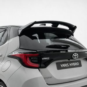 Rear view of a silver Toyota Yaris Hybrid, showing taillights, logo, and 'YARIS HYBRID' badge on the hatchback
