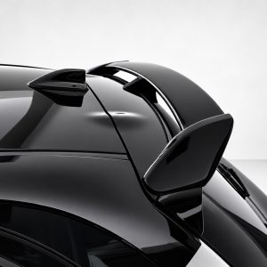 A-541_4jpg - OPSHOLDERS Close-up of a sleek black car rear with a spoiler and glossy curved bodywork.