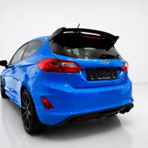A-542_2jpg - OPSHOLDERS Blue Ford hatchback viewed from the rear in a white studio, showing a spoiler and red tail lights.