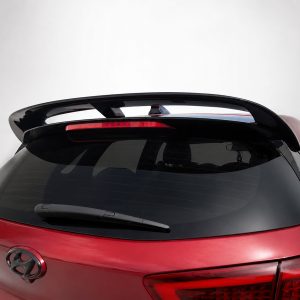 Red Hyundai hatchback rear with a large spoiler and high-mounted brake light above the rear window.