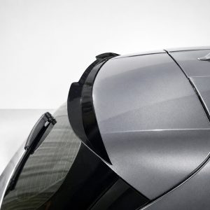 A-546_3jpg - OPSHOLDERS Close-up of a silver car's rear roofline and spoiler with curved panels and glossy finish.
