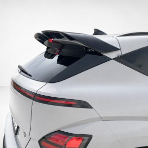 Rear three-quarter view of a silver SUV with a large black spoiler and tinted rear window.