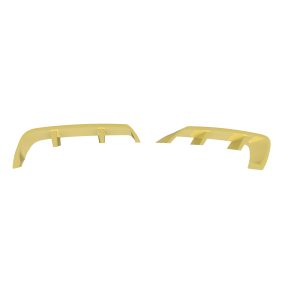 Two yellow curved plastic parts with rectangular supports laid apart on a white background