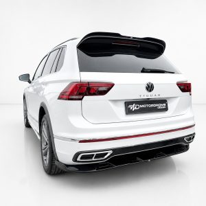 Rear view of a white Volkswagen Tiguan SUV in a studio setting, showing the taillights, rear window, and spoiler.