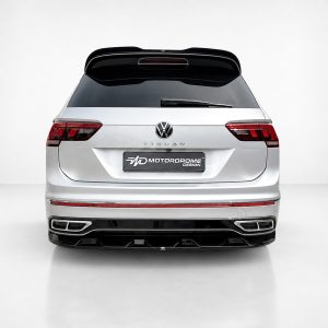Rear view of a silver Volkswagen Tiguan SUV with a Motordrome Design license plate in a clean studio setting