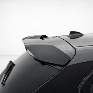 Close-up of a glossy dark car roof with a rear spoiler and shark-fin antenna, showing smooth reflections.