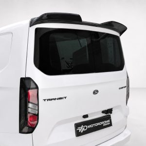 Rear view of a white Ford Transit van with a dark rear window and roof spoiler on a neutral backdrop.