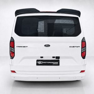A-550_3jpg - OPSHOLDERS Rear view of a white Ford Transit Custom van with Ford emblem, badge text, and a Motordrome Design plate on a neutral background