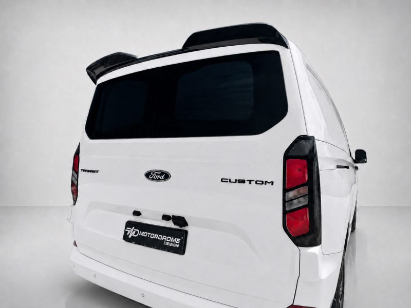 A-550_4jpg - OPSHOLDERS White Ford Transit Custom van seen from rear-right, displaying black-tinted rear window and custom Motordome Design license plate.