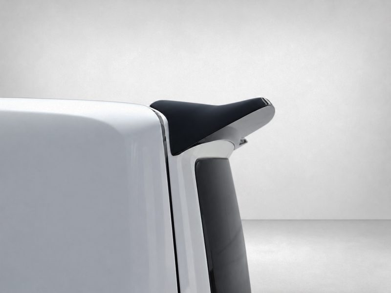 A-550_6jpg - OPSHOLDERS Close-up of a white vehicle's rear with a black spoiler mounted on the tailgate edge.