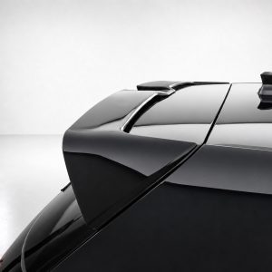Rear view of a sleek black car showing a spoiler and glossy finish against a light background.