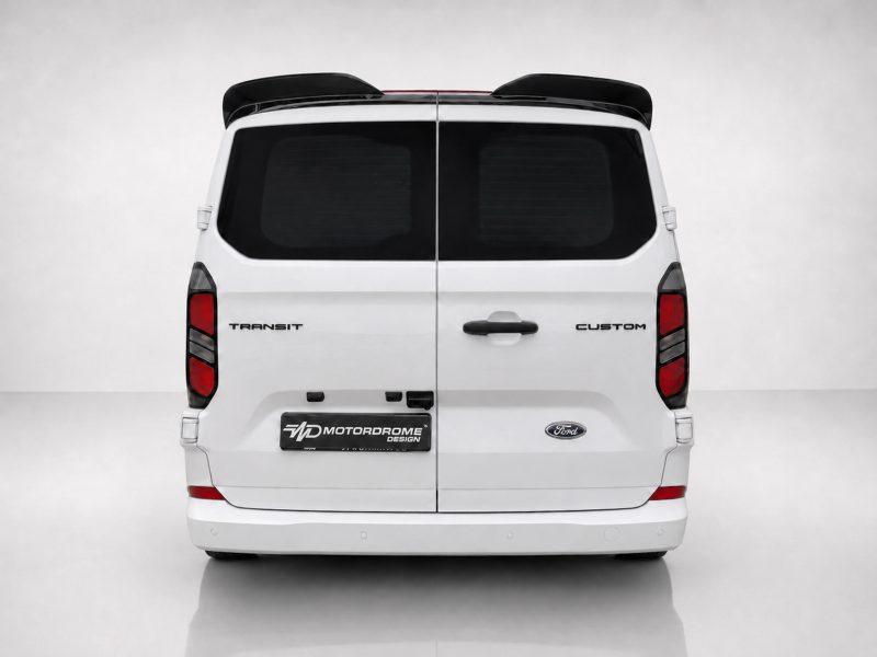 Rear view of a white Ford Transit Custom van in a studio setting, showing the split doors and rear lights on a clean backdrop.