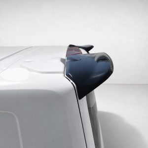 White vehicle seen from the rear side with a black rear spoiler on the roofline, against a neutral background.